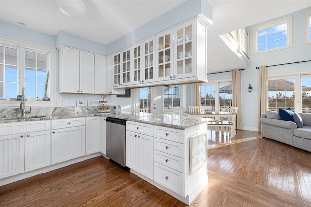 57 Foster St, Warwick, RI 02889 - kitchen with stainless steel dishwasher, dark wood finished floors, a sink, a peninsula, and white cabinets