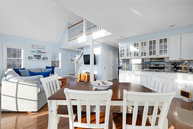 57 Foster St, Warwick, RI 02889 - dining area with stairway, high vaulted ceiling, plenty of natural light, and wood finished floors