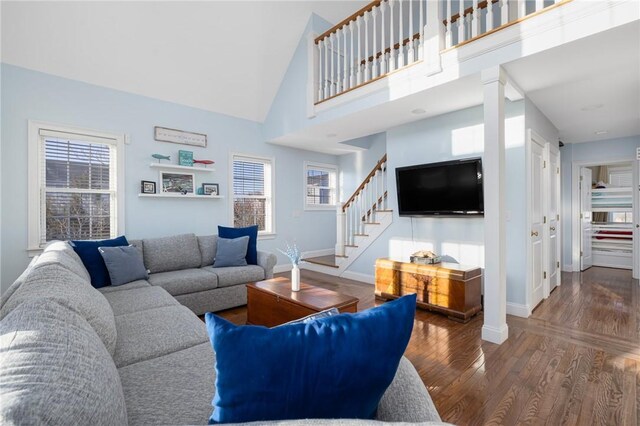 57 Foster St, Warwick, RI 02889 - living area featuring stairway, wood finished floors, baseboards, and a healthy amount of sunlight