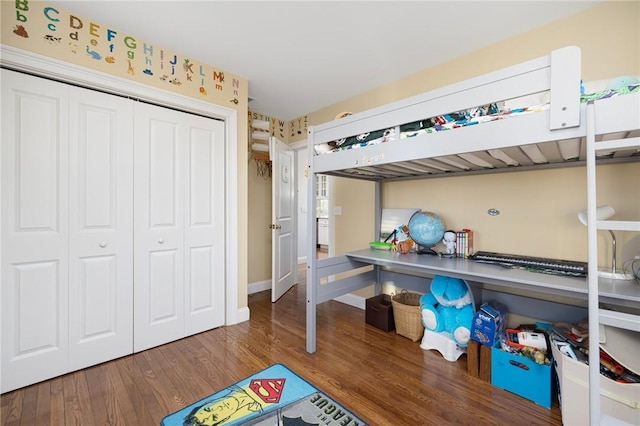 57 Foster St, Warwick, RI 02889 - bedroom with baseboards, a closet, and wood finished floors