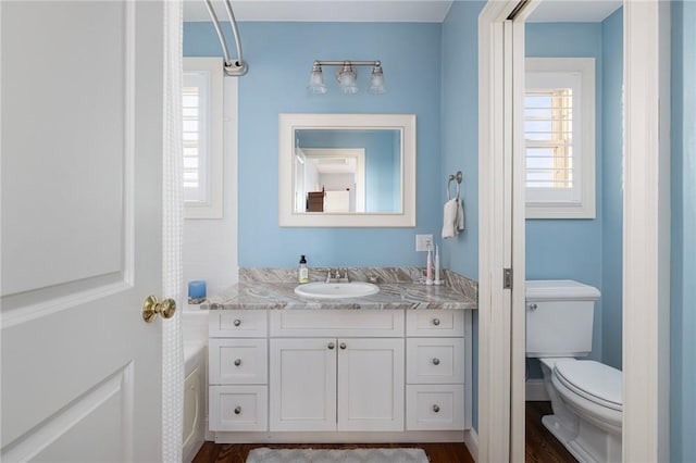 57 Foster St, Warwick, RI 02889 - bathroom with toilet, wood finished floors, and vanity