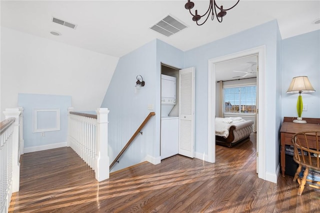 57 Foster St, Warwick, RI 02889 - interior space with visible vents, an inviting chandelier, stacked washer / dryer, and wood finished floors