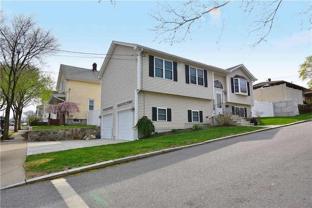 1 Augusta St, Providence, RI 02908 - bi-level home with a garage, fence, driveway, and a front yard
