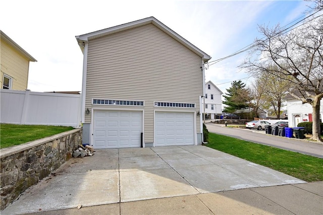1 Augusta St, Providence, RI 02908 - view of side of property with fence, an attached garage, and driveway
