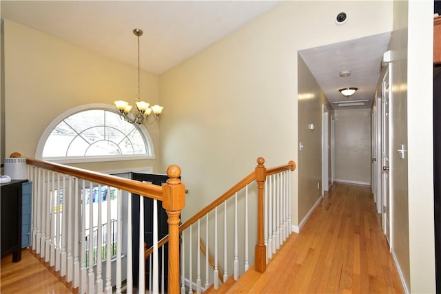 1 Augusta St, Providence, RI 02908 - corridor with vaulted ceiling, baseboards, an upstairs landing, an inviting chandelier, and light wood-style flooring