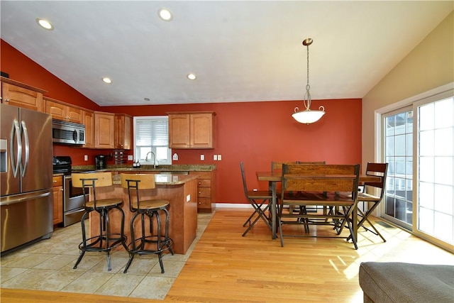 1 Augusta St, Providence, RI 02908 - kitchen with appliances with stainless steel finishes, a breakfast bar area, a center island, recessed lighting, and vaulted ceiling