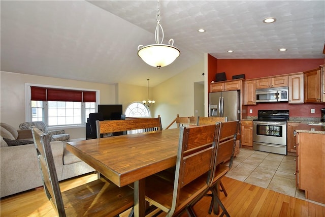 1 Augusta St, Providence, RI 02908 - dining space with an inviting chandelier, light wood-style floors, and vaulted ceiling