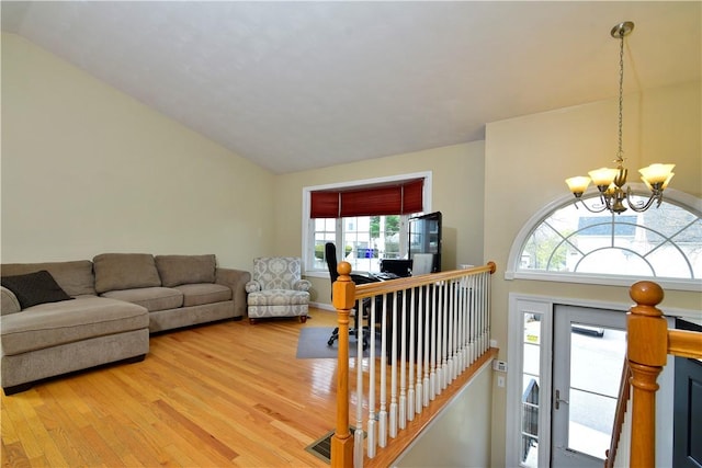1 Augusta St, Providence, RI 02908 - living room featuring light wood finished floors, lofted ceiling, and a notable chandelier