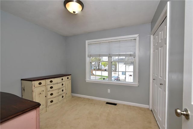 1 Augusta St, Providence, RI 02908 - bedroom featuring baseboards, visible vents, light carpet, and a closet