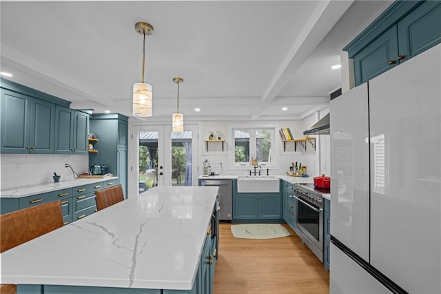 kitchen with decorative backsplash, open shelves, a sink, appliances with stainless steel finishes, and recessed lighting