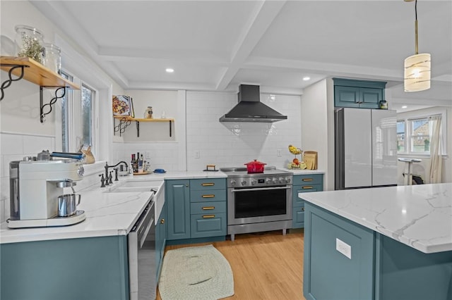 kitchen with open shelves, a sink, appliances with stainless steel finishes, wall chimney exhaust hood, and a wealth of natural light