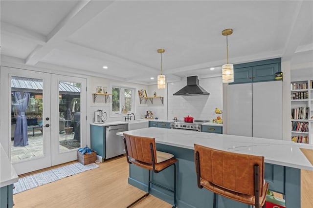 kitchen with a sink, open shelves, wall chimney exhaust hood, stainless steel dishwasher, and french doors