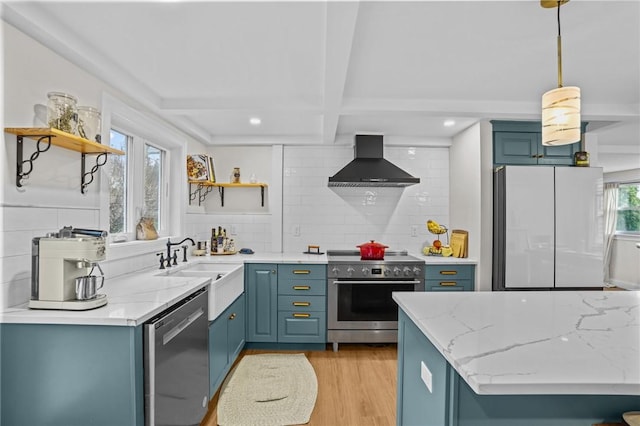 kitchen featuring tasteful backsplash, open shelves, appliances with stainless steel finishes, light wood-type flooring, and wall chimney exhaust hood