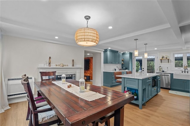 dining room featuring beam ceiling, a fireplace, light wood-style floors, and recessed lighting