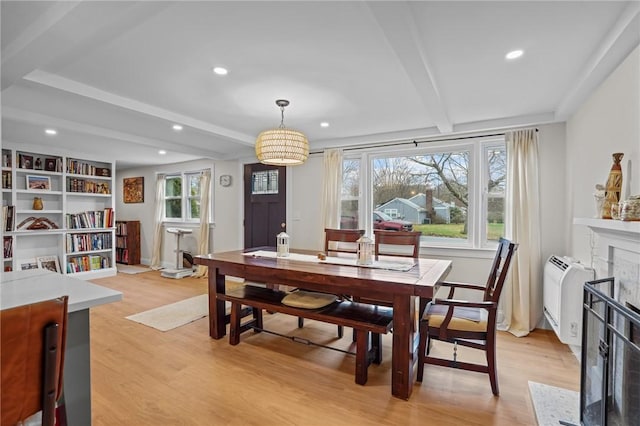 dining room with recessed lighting, beamed ceiling, and light wood finished floors