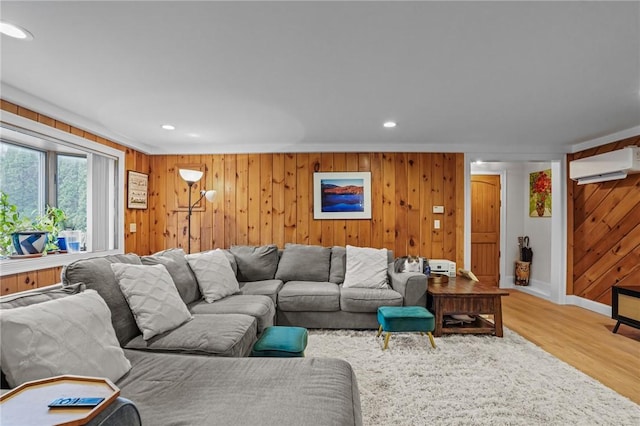 living area featuring wood walls, wood finished floors, recessed lighting, and a wall mounted AC