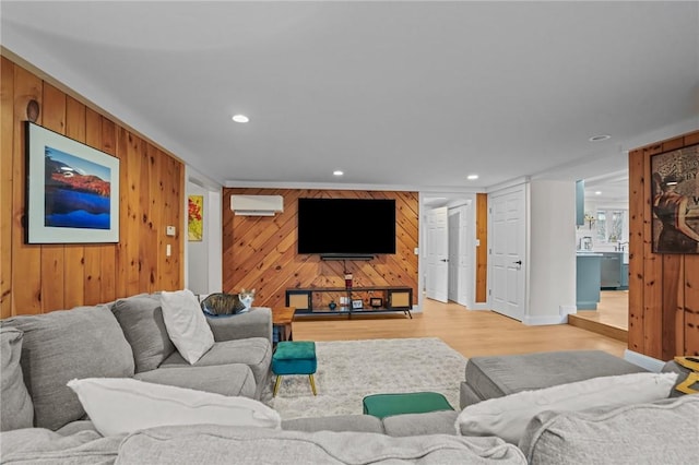 living area featuring wooden walls, recessed lighting, a wall unit AC, and light wood-style floors