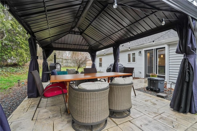 view of patio with area for grilling, outdoor dining space, and a gazebo