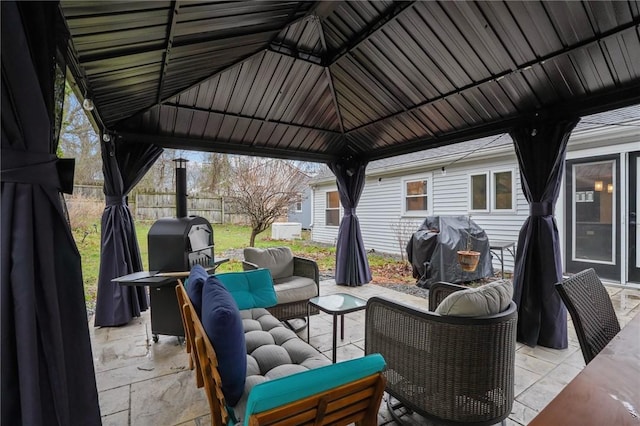 view of patio / terrace featuring outdoor lounge area, fence, a gazebo, and a grill