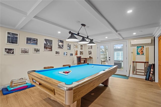 game room with light wood-style floors, a wall unit AC, coffered ceiling, and french doors
