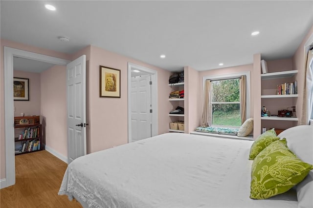 bedroom with baseboards, recessed lighting, and wood finished floors