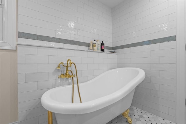 full bathroom with a freestanding tub and tile walls