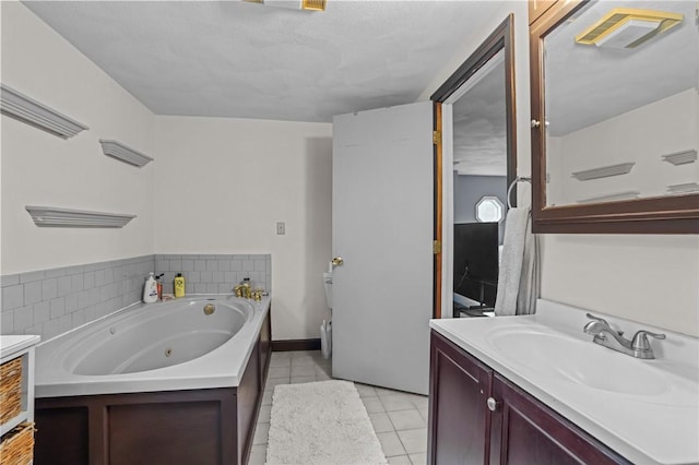 full bathroom with tile patterned floors, a tub with jets, and vanity