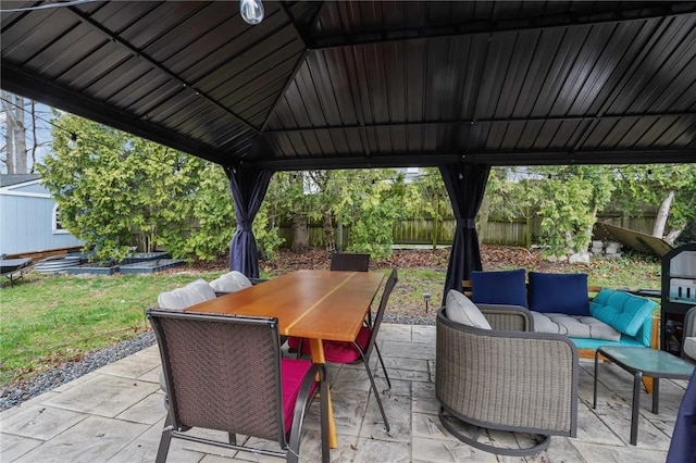 view of patio with fence, outdoor dining space, and an outdoor living space