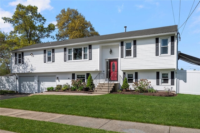 136 Wilde Field Dr, Warwick, RI 02889 - split foyer home featuring an attached garage, driveway, and a front yard