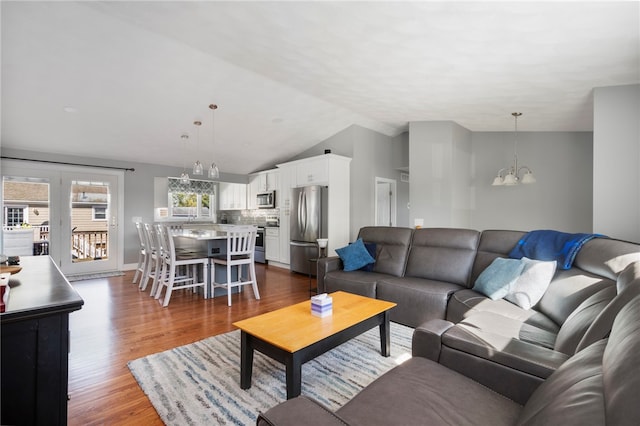 136 Wilde Field Dr, Warwick, RI 02889 - living room with an inviting chandelier, wood finished floors, and lofted ceiling