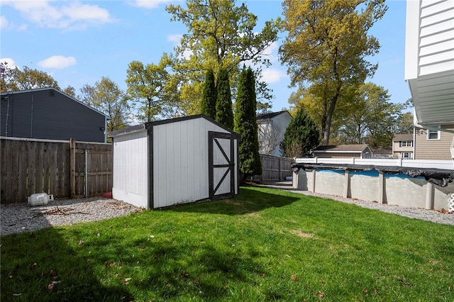 136 Wilde Field Dr, Warwick, RI 02889 - view of yard featuring a fenced backyard, a storage unit, an outdoor structure, and a fenced in pool