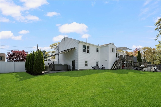 136 Wilde Field Dr, Warwick, RI 02889 - rear view of house featuring fence, a wooden deck, stairway, central air condition unit, and a lawn
