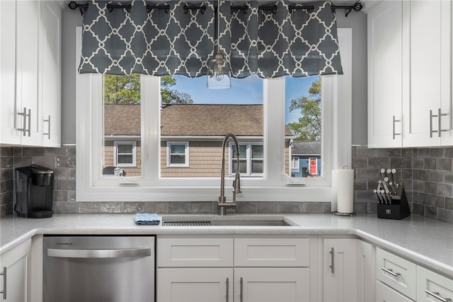 136 Wilde Field Dr, Warwick, RI 02889 - kitchen featuring white cabinets, a sink, light countertops, decorative backsplash, and stainless steel dishwasher