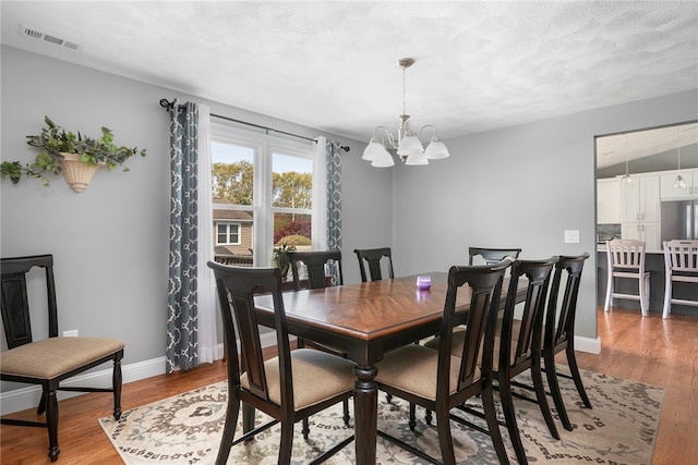 136 Wilde Field Dr, Warwick, RI 02889 - dining space featuring visible vents, baseboards, light wood finished floors, and a chandelier