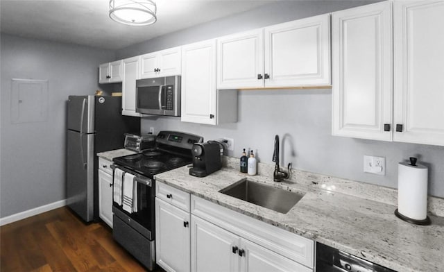 200 Manville Hill Rd Unit 126, Cumberland, RI 02864 - kitchen featuring white cabinets, light stone countertops, a sink, stainless steel appliances, and baseboards