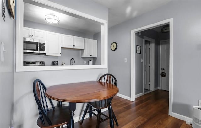 200 Manville Hill Rd Unit 126, Cumberland, RI 02864 - dining room with baseboards and dark wood finished floors