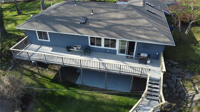 63 Duck Cove Rd, North Kingstown, RI 02852 - back of property featuring a shingled roof, a wooden deck, and a chimney