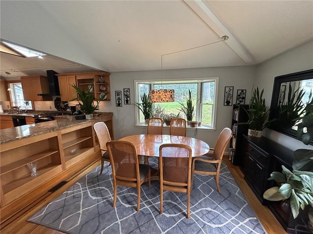 63 Duck Cove Rd, North Kingstown, RI 02852 - dining space with lofted ceiling with beams, dark wood finished floors, and a wealth of natural light