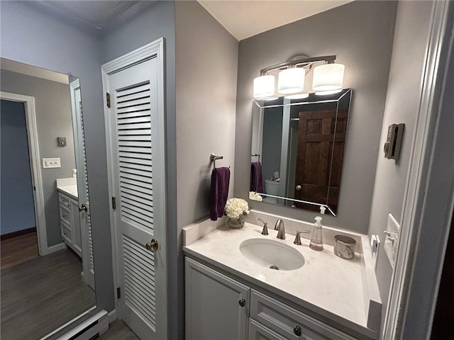 63 Duck Cove Rd, North Kingstown, RI 02852 - bathroom with vanity, baseboards, and wood finished floors