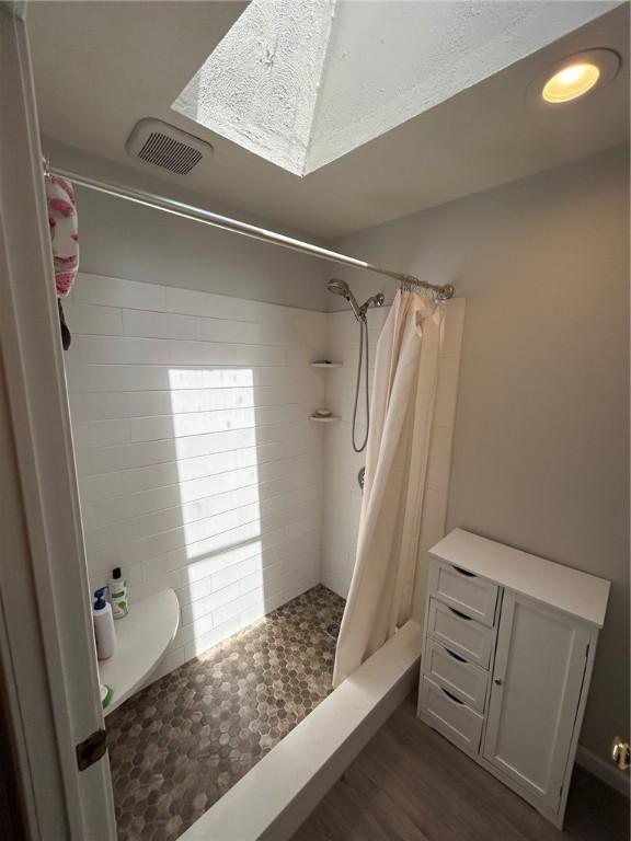 63 Duck Cove Rd, North Kingstown, RI 02852 - full bathroom with visible vents, a stall shower, and wood finished floors