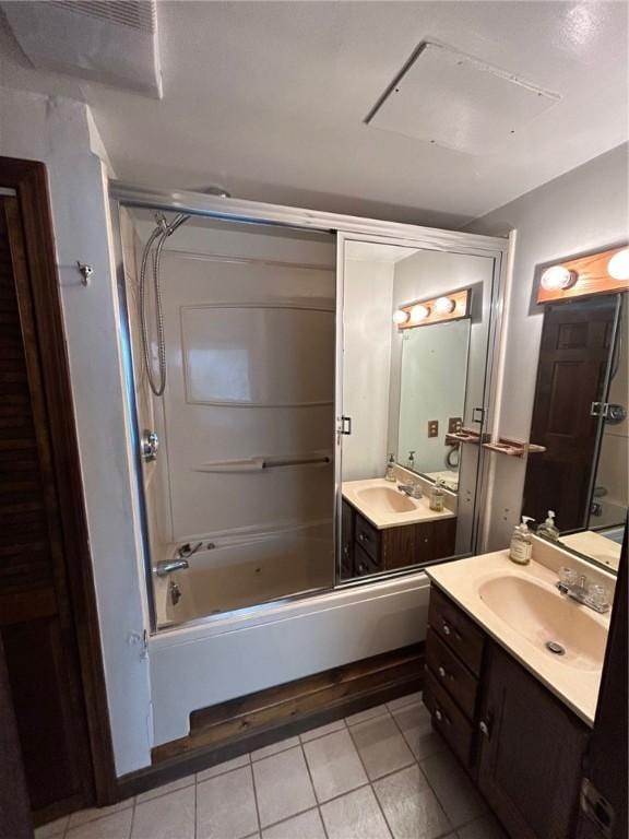63 Duck Cove Rd, North Kingstown, RI 02852 - bathroom featuring two vanities, tile patterned floors, combined bath / shower with glass door, and a sink