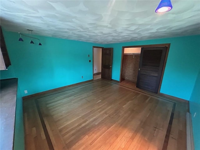 63 Duck Cove Rd, North Kingstown, RI 02852 - unfurnished bedroom with baseboards, wood finished floors, and a closet