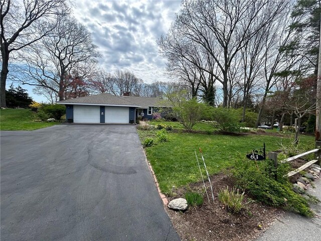 63 Duck Cove Rd, North Kingstown, RI 02852 - single story home with an attached garage, driveway, a chimney, and a front lawn