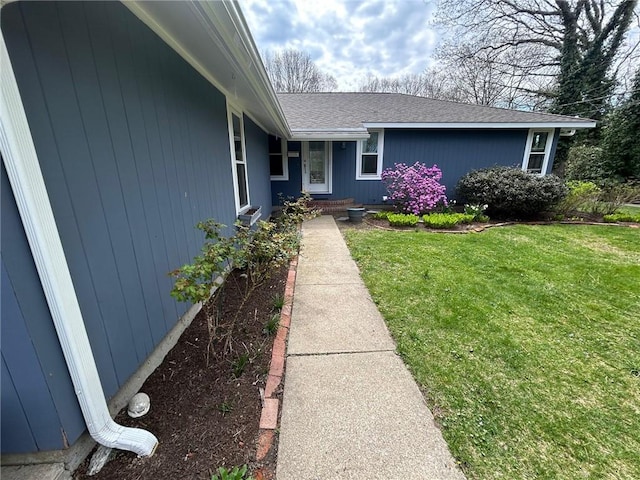 63 Duck Cove Rd, North Kingstown, RI 02852 - property entrance featuring a lawn and a shingled roof