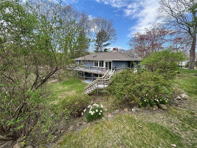 63 Duck Cove Rd, North Kingstown, RI 02852 - rear view of property with stairway, a deck, a yard, and a chimney