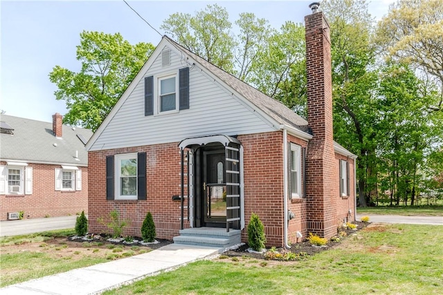 46 Freeman St, Warwick, RI 02886 - bungalow-style home featuring brick siding, a chimney, and a front lawn