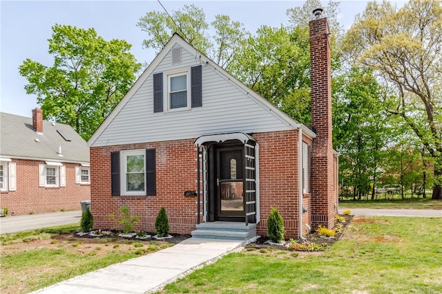 46 Freeman St, Warwick, RI 02886 - view of front of house with brick siding and a front yard
