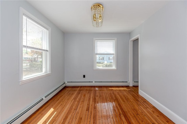 46 Freeman St, Warwick, RI 02886 - empty room featuring a chandelier, baseboards, a baseboard heating unit, and light wood-style flooring