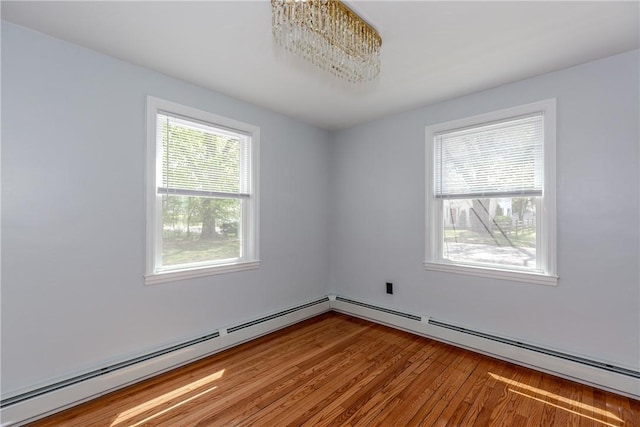 46 Freeman St, Warwick, RI 02886 - unfurnished room with a baseboard heating unit and wood finished floors