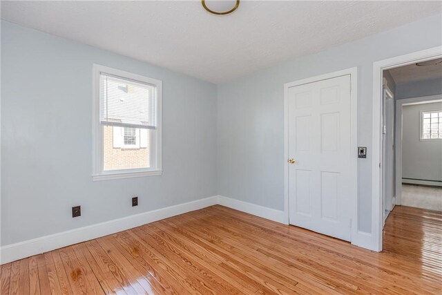 46 Freeman St, Warwick, RI 02886 - spare room with baseboards, a baseboard heating unit, and light wood finished floors